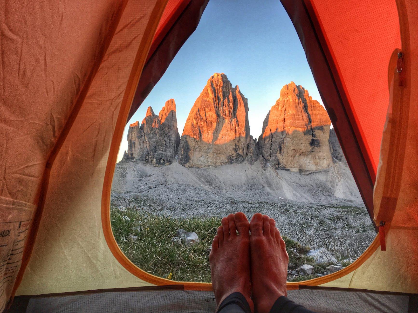 person inside tent near mountains